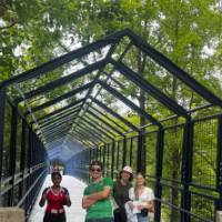 Students posing for a picture by the blue bridge at GVSU during orientation